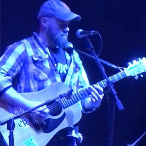 Dusty Workman live at the State House, bathed in blue light